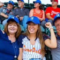 Family of three posing at the Comerica Park event